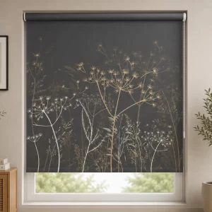 Dark charcoal grey PVC roller blind with elegant botanical floral pattern installed in a modern living room