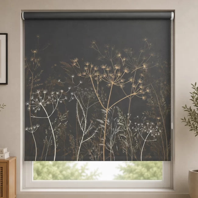 Dark charcoal grey PVC roller blind with elegant botanical floral pattern installed in a modern living room